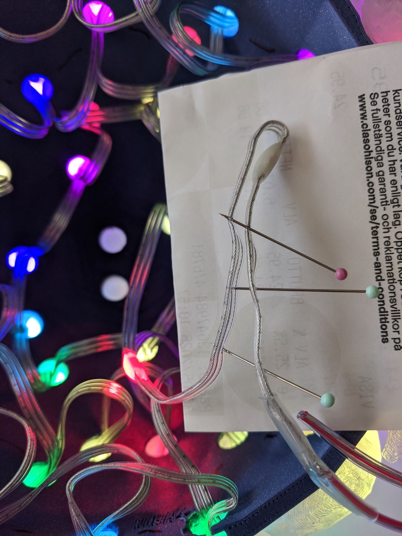Jumping the first LED with three sewing pins through the wires.